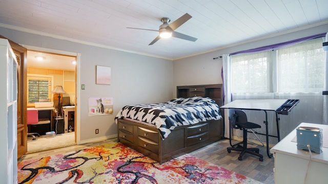 bedroom featuring multiple windows, ceiling fan, light wood-type flooring, and crown molding