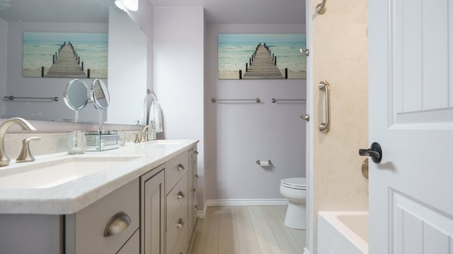 bathroom with toilet and double sink vanity