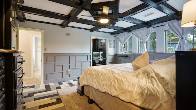 bedroom featuring ceiling fan, beam ceiling, and coffered ceiling