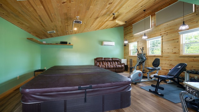 playroom with lofted ceiling, wooden walls, and hardwood / wood-style flooring