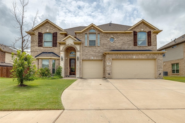 view of front of home featuring a garage, concrete driveway, brick siding, and a front lawn