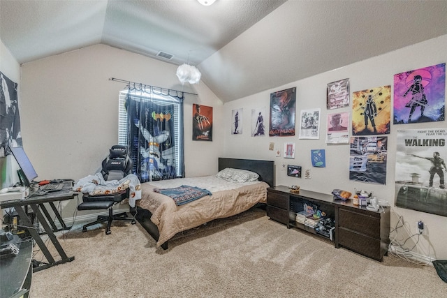 bedroom featuring carpet, vaulted ceiling, and a textured ceiling