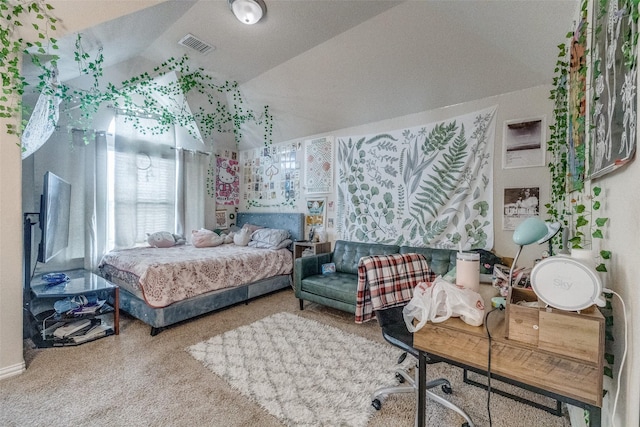 bedroom featuring lofted ceiling and visible vents