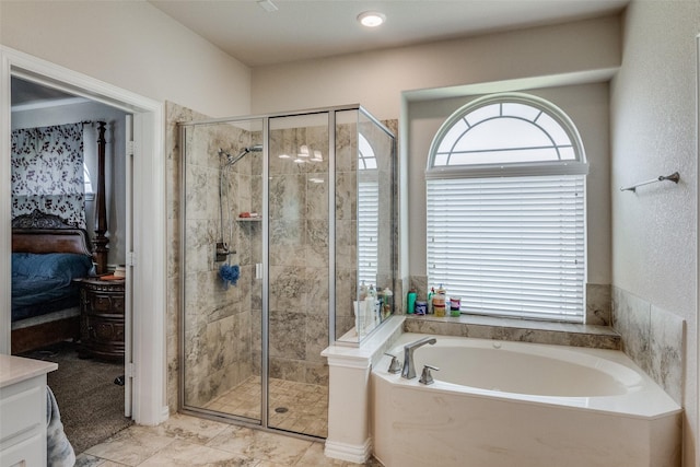 ensuite bathroom with a garden tub, a shower stall, and ensuite bathroom