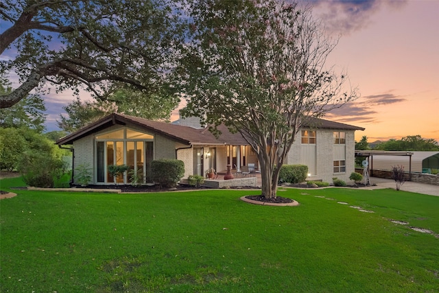 view of front facade featuring a carport and a yard