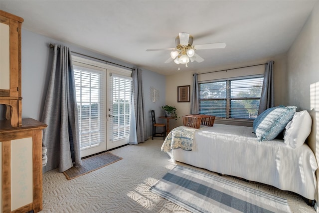 bedroom featuring french doors, light colored carpet, ceiling fan, and access to outside