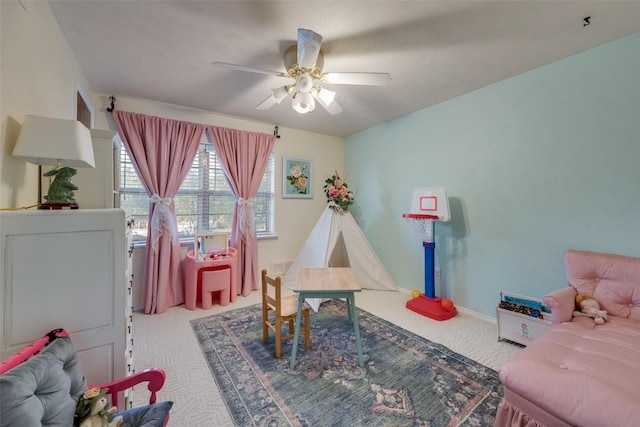 recreation room with light carpet and ceiling fan