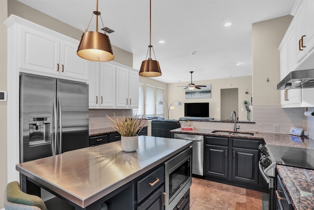 kitchen with white cabinetry, backsplash, appliances with stainless steel finishes, and sink