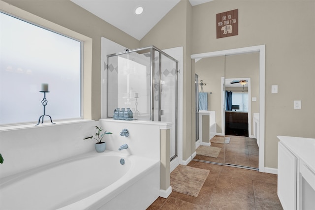 bathroom with vanity, lofted ceiling, tile patterned floors, and separate shower and tub