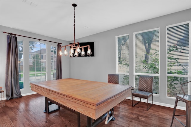 dining space with a chandelier and dark hardwood / wood-style floors