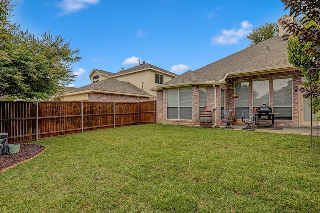 rear view of property featuring a patio area and a lawn