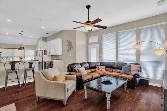 living room featuring ceiling fan and dark hardwood / wood-style flooring