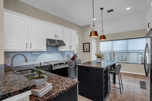 kitchen with a kitchen island, a breakfast bar area, sink, pendant lighting, and appliances with stainless steel finishes