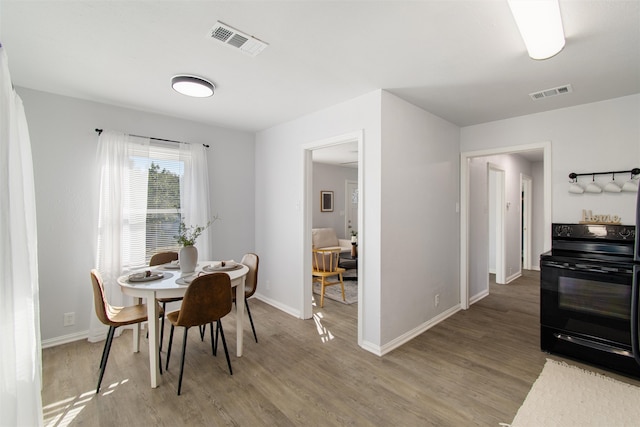 dining area with hardwood / wood-style flooring