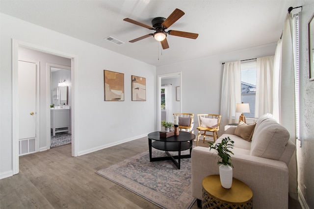 living room featuring ceiling fan and hardwood / wood-style flooring