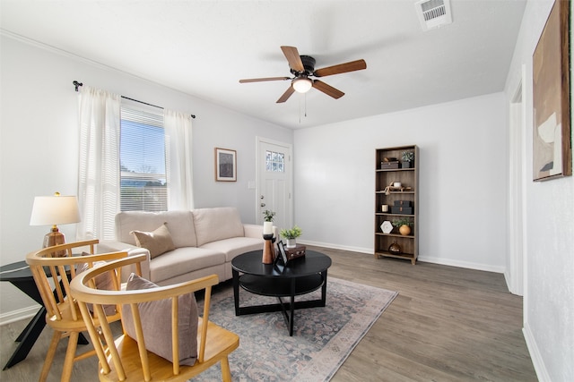 living room with wood-type flooring and ceiling fan