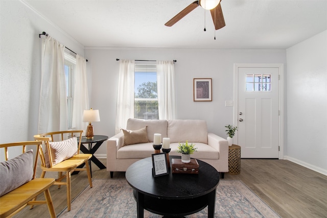 living room with ornamental molding, ceiling fan, and hardwood / wood-style floors