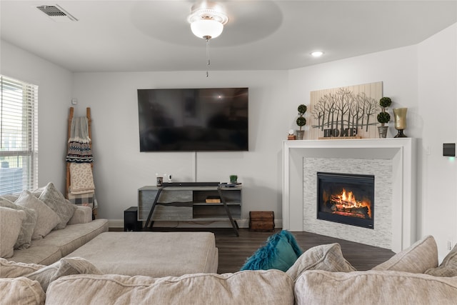 living room with dark hardwood / wood-style floors and ceiling fan