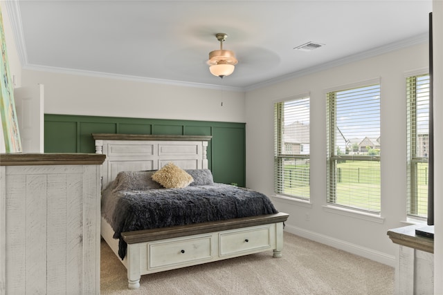 bedroom with crown molding and light colored carpet