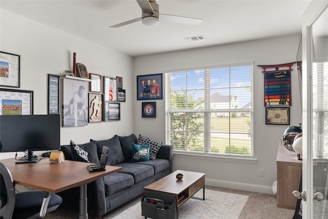 carpeted living room featuring ceiling fan