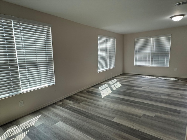 unfurnished room with dark hardwood / wood-style floors