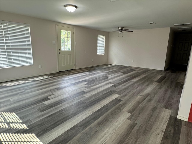 interior space featuring dark wood-type flooring and ceiling fan