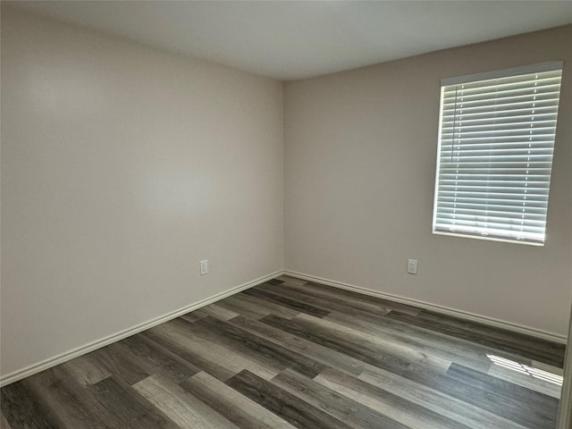 spare room with dark hardwood / wood-style flooring