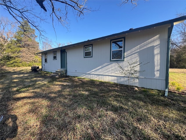 rear view of property featuring a lawn