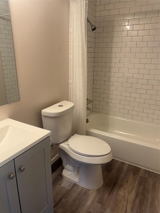 full bathroom with vanity, hardwood / wood-style floors, shower / bath combination with curtain, and toilet