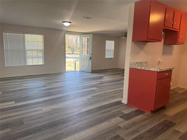 kitchen with ceiling fan and dark hardwood / wood-style flooring