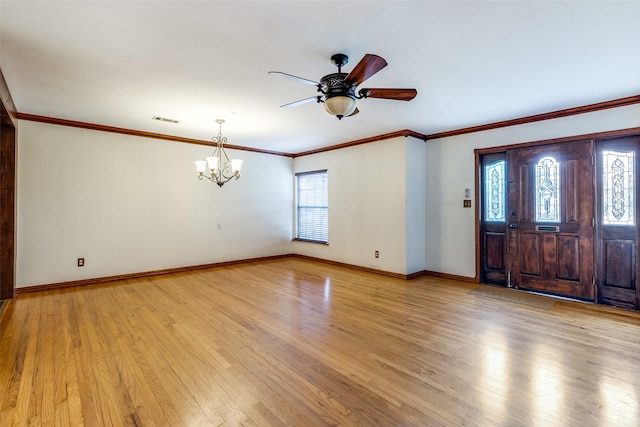 foyer entrance with ceiling fan with notable chandelier, light hardwood / wood-style flooring, plenty of natural light, and ornamental molding