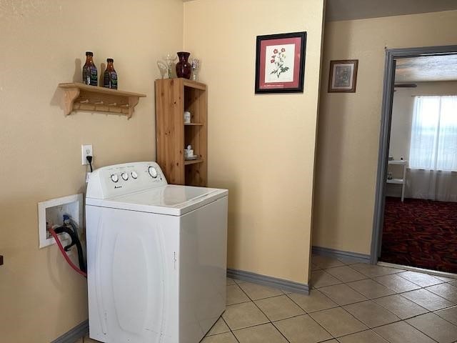 laundry room with washer / dryer and light tile patterned floors