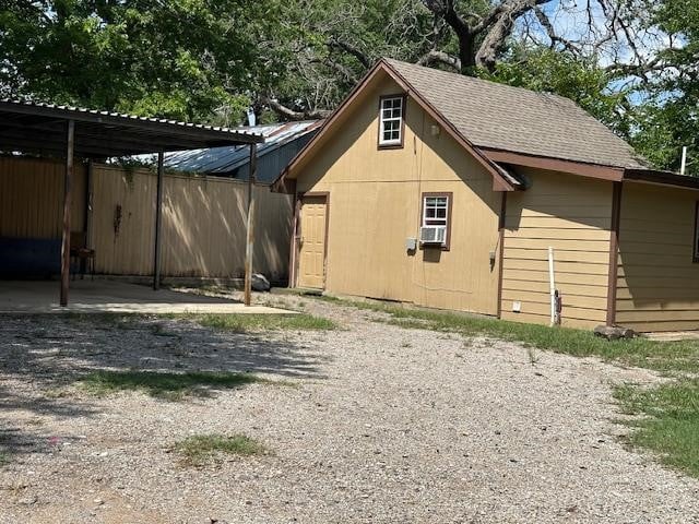 rear view of property featuring a carport