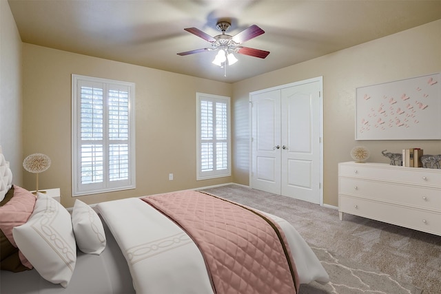 bedroom featuring a closet, carpet flooring, and ceiling fan