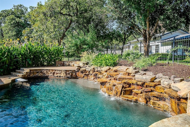 view of pool with pool water feature