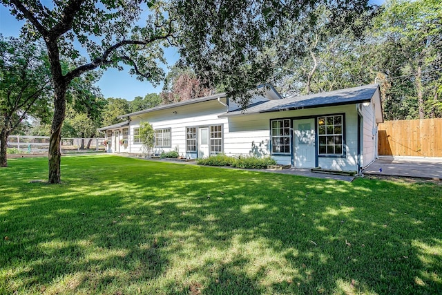 back of house featuring a lawn