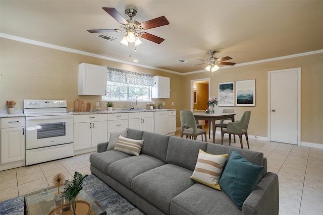 living room featuring crown molding, sink, light tile patterned floors, and ceiling fan