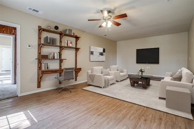 living room with ceiling fan and light hardwood / wood-style floors