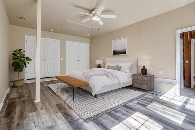 bedroom featuring multiple closets, wood-type flooring, and ceiling fan