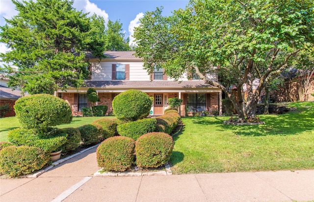 view of property featuring a front lawn