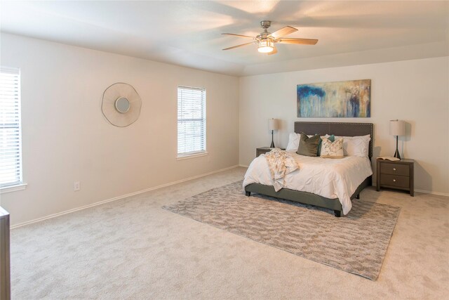 bedroom featuring light colored carpet and ceiling fan