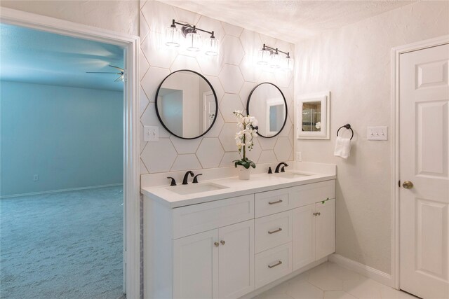 bathroom with decorative backsplash, vanity, and ceiling fan