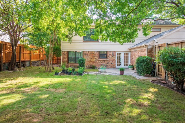 rear view of property with a lawn, french doors, and a patio