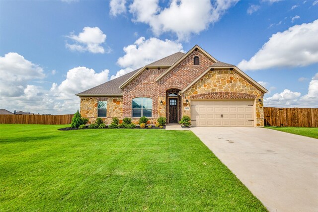 view of front of house featuring a garage and a front lawn