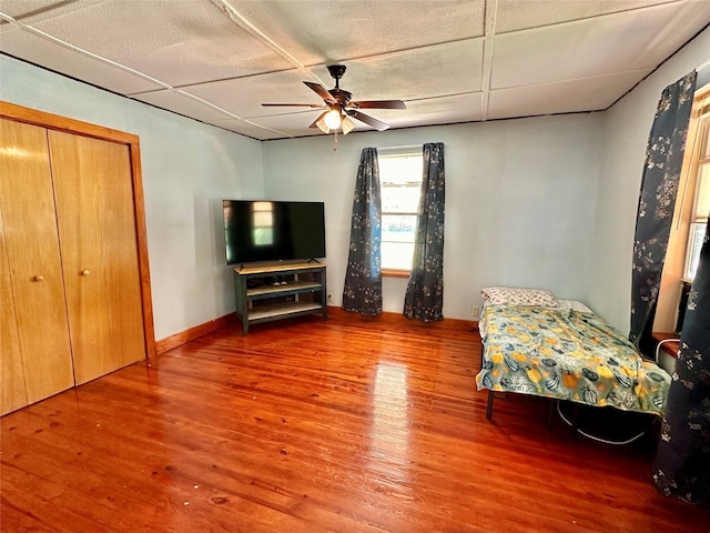 unfurnished bedroom featuring a closet, ceiling fan, and hardwood / wood-style flooring