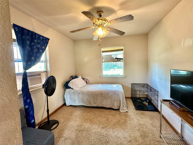 bedroom featuring multiple windows, light colored carpet, and ceiling fan