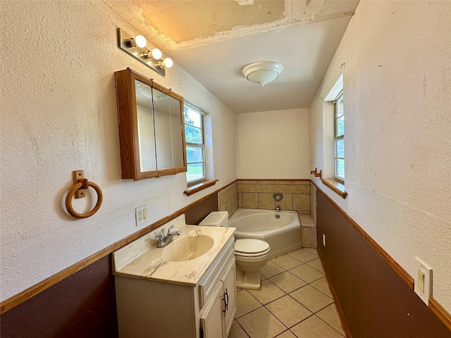 bathroom featuring vanity, toilet, a tub, and tile patterned flooring