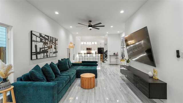 living room with light hardwood / wood-style floors and ceiling fan