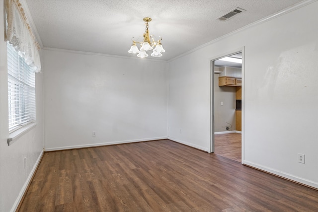 unfurnished room featuring an inviting chandelier, crown molding, a textured ceiling, and dark hardwood / wood-style flooring