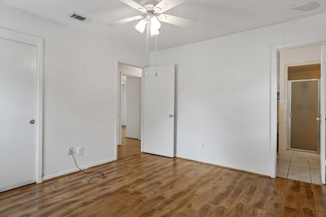 unfurnished bedroom featuring ceiling fan and hardwood / wood-style floors